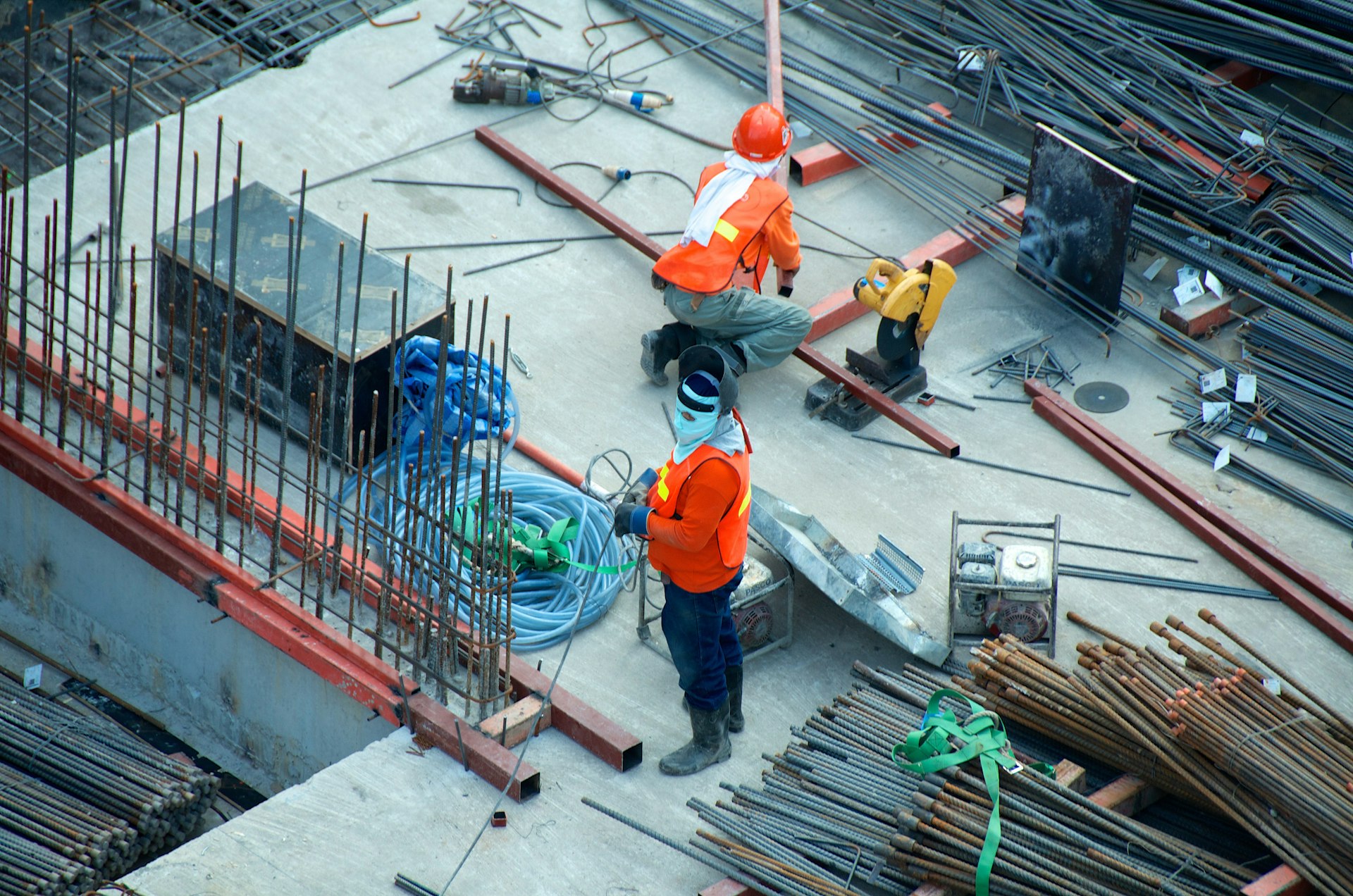 Steel frame rising on an active construction site at sunset
